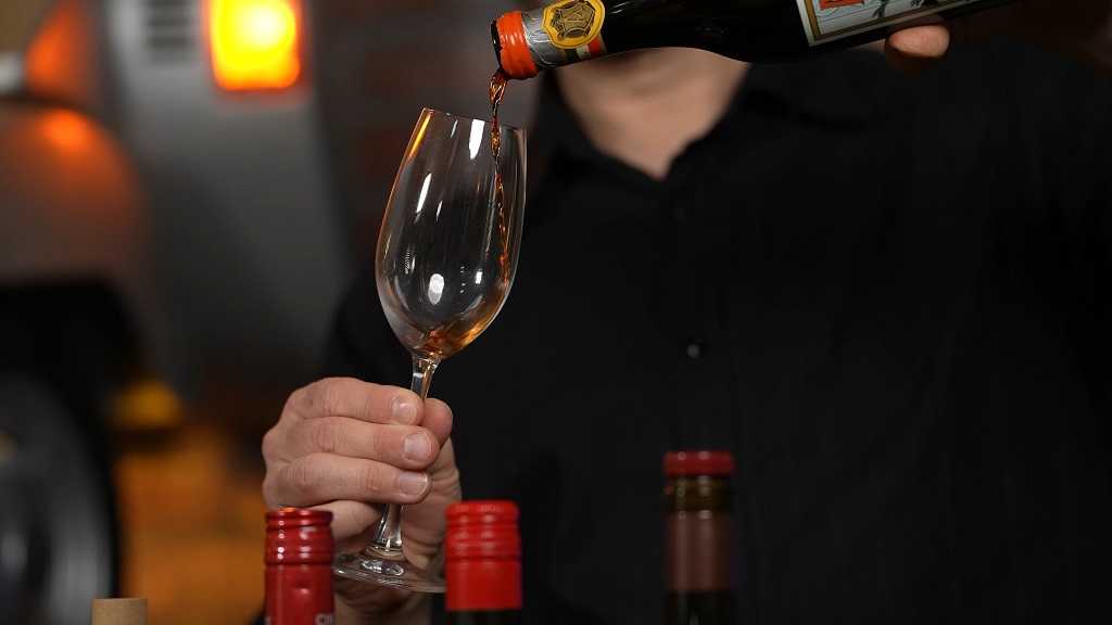 Pouring sweet vermouth into a glass