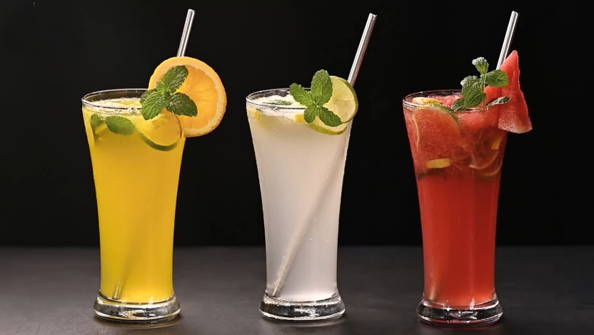 Refreshing fruit-infused cocktails in tall glasses