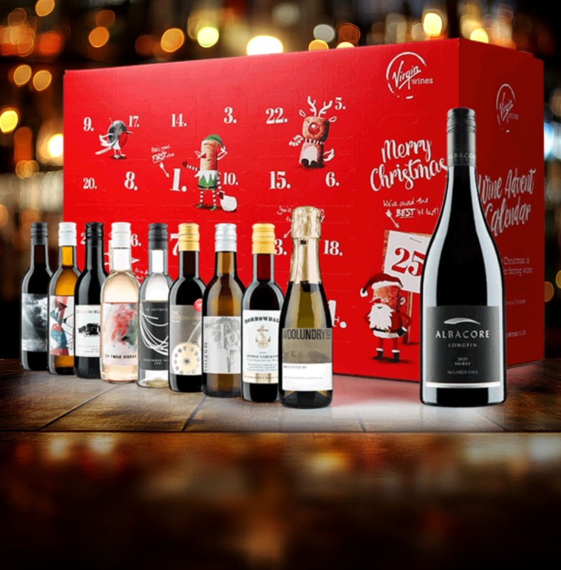 A red Virgin Wines advent calendar box with numbered doors for each day of December, accompanied by 10 mini wine bottles displayed in front, set against a festive bar-themed background