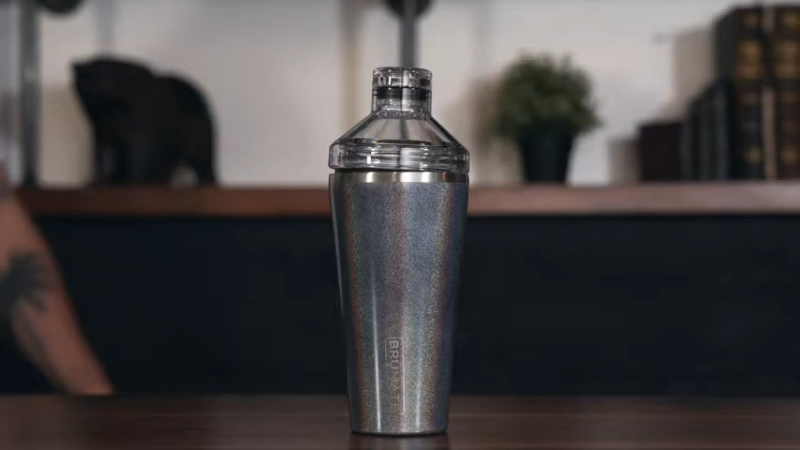 A Close-Up Image of An Insulated Cocktail Shaker with A Sleek, Modern Design on A Wooden Surface