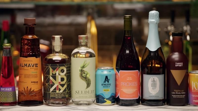 A variety of alcohol-free spirits bottles displayed on a bar counter