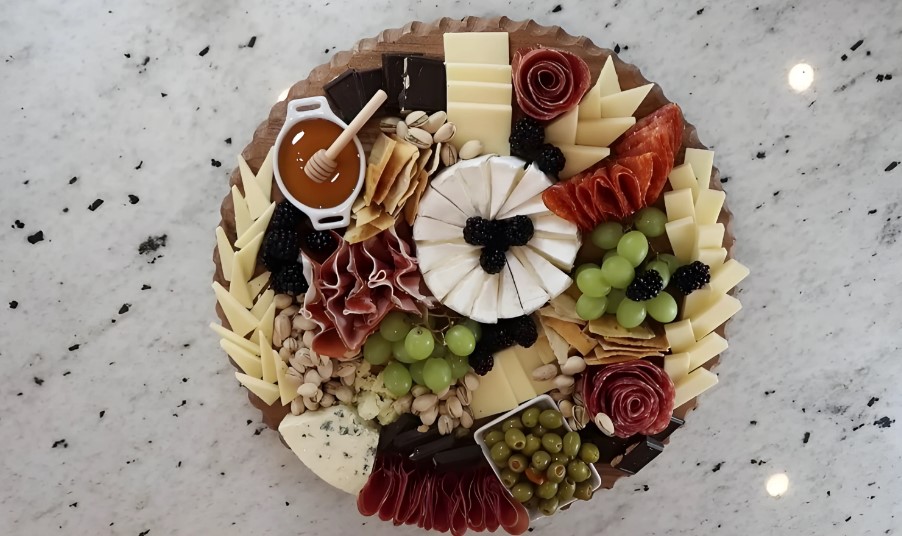 A curated selection of cheeses, cured meats, and fruits